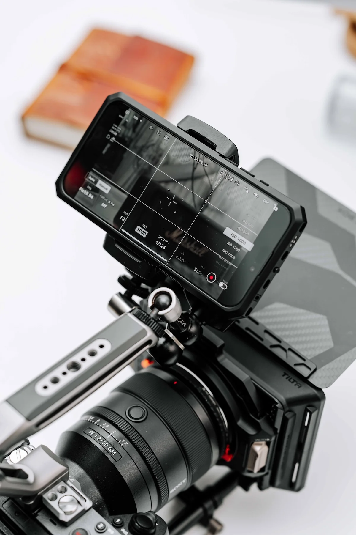 A professional camera production setup with a monitor, camera body, lens, and rig